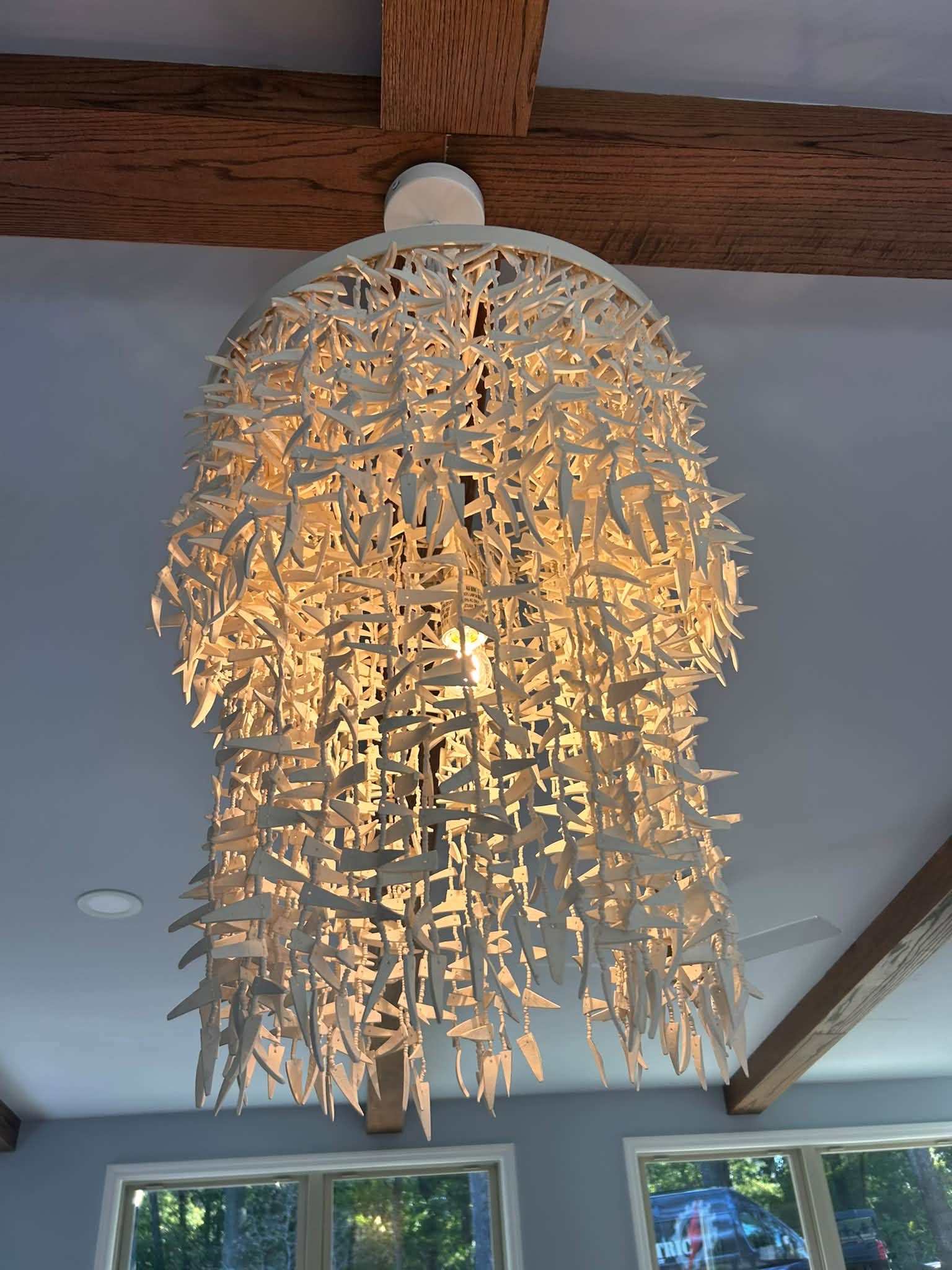 Sculptural statement pendant light with warm wood ceiling details